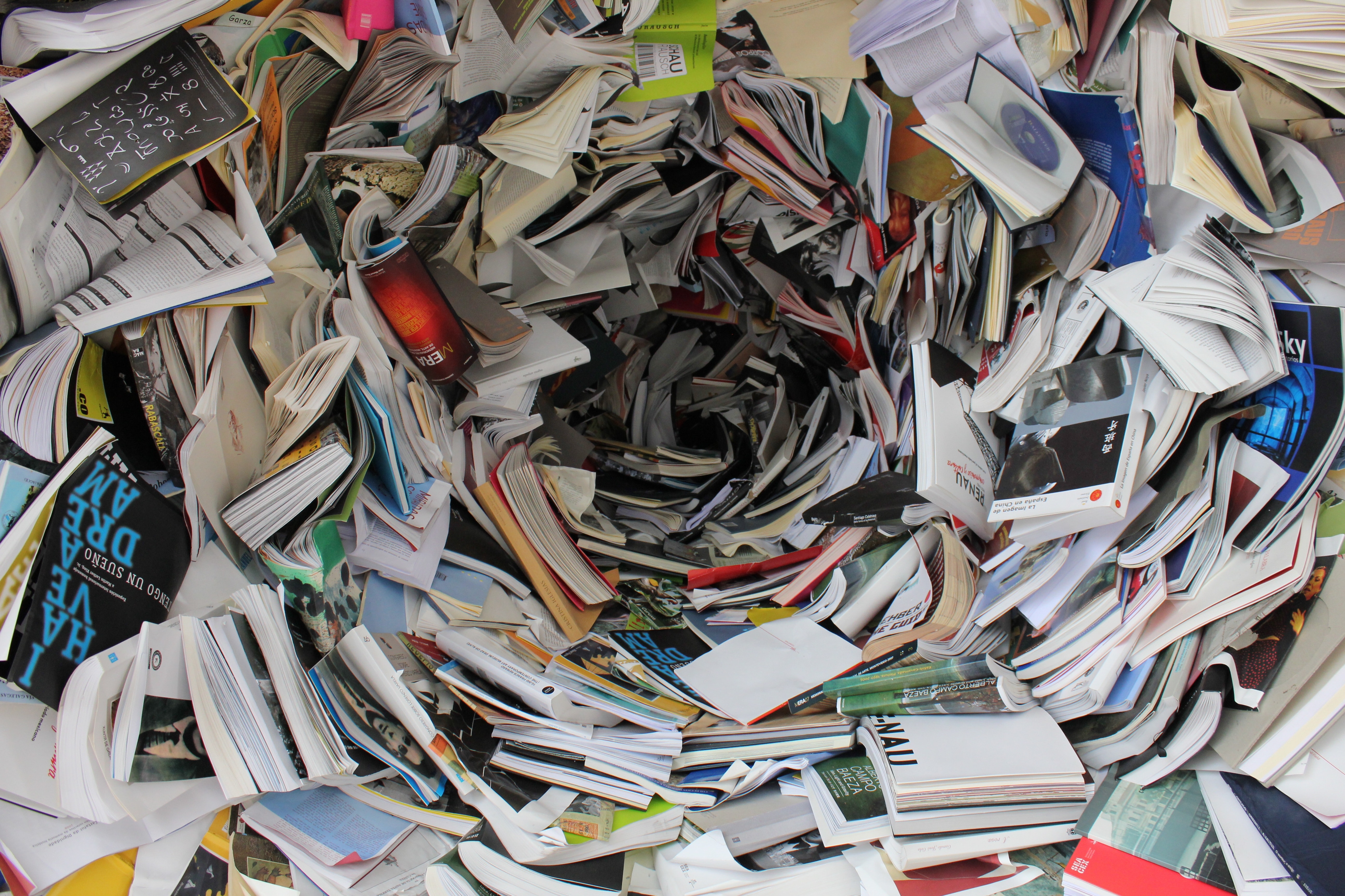 A vast number of books in chaotic states seem to swirl down a whirlpool.